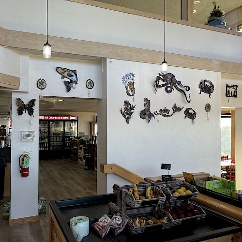 The image shows the interior of a shop with wall decor, including animal figures, hanging lights, fruit display, and a staircase leading upstairs.